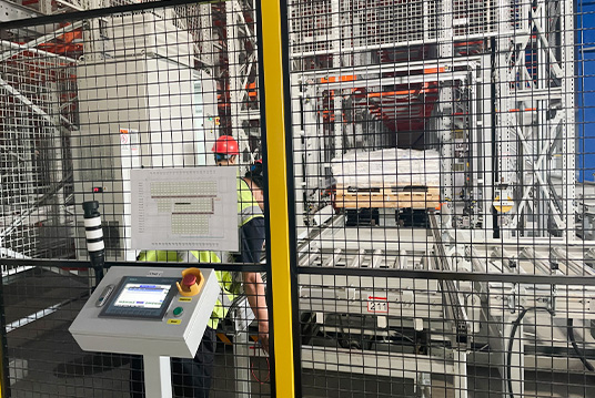 Safety isolation fence protecting automated storage and retrieval system equipment inside warehouse