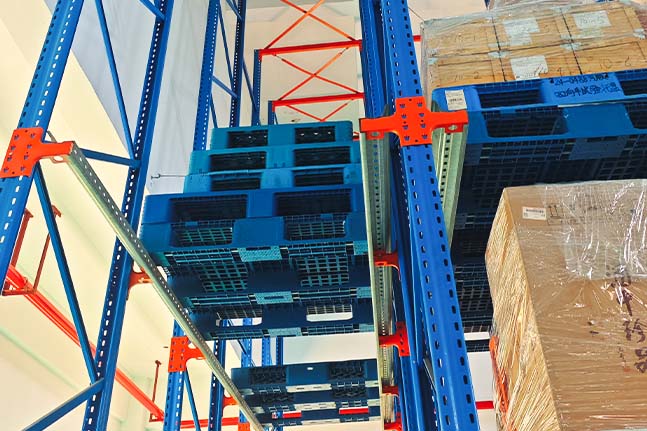 Close-up view of a drive-in pallet racking system showing its structural components.