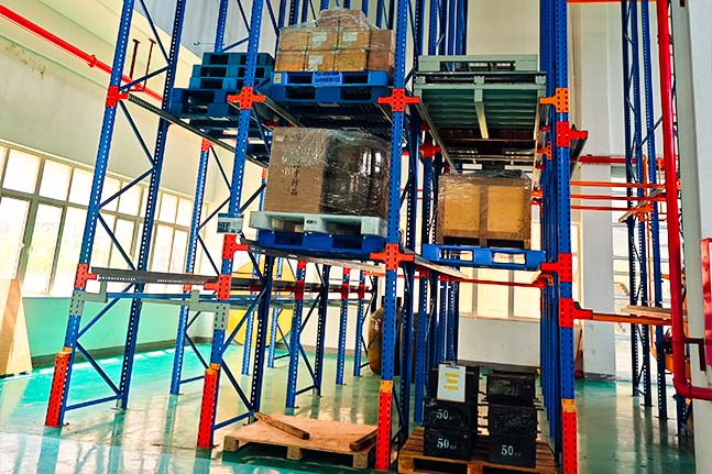 Drive-in pallet racking system installed in a warehouse for high-density pallet storage.
