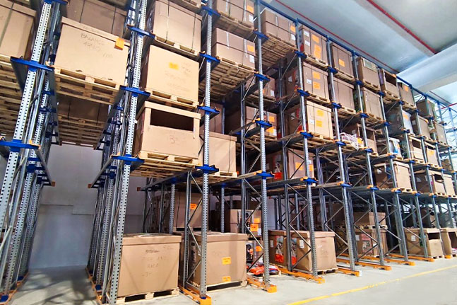 Drive-in pallet racking system for high-density pallet storage in a warehouse.