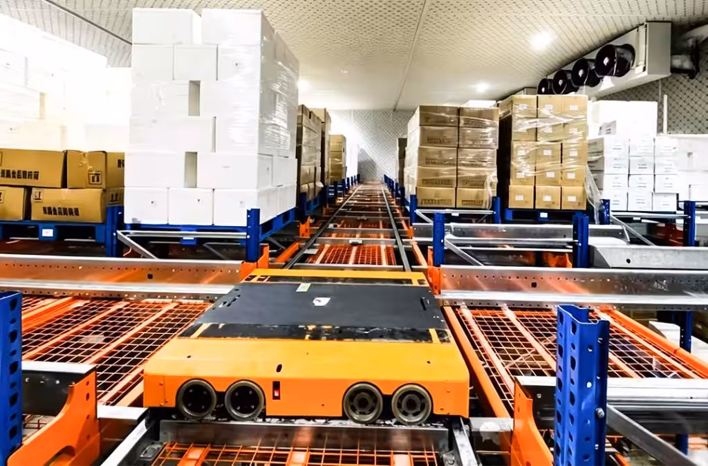 Four way pallet shuttle carrying a pallet inside an automated warehouse racking system
