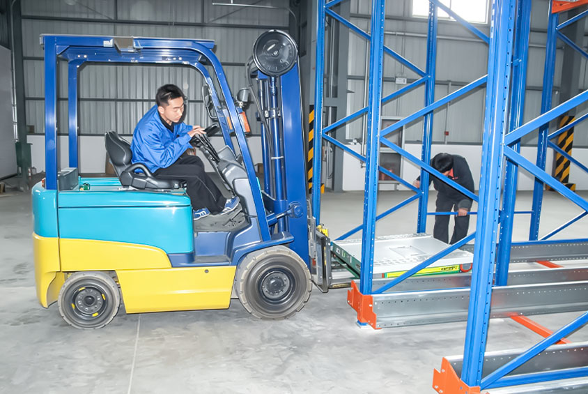Pallet shuttle system with forklift placing a radio shuttle vehicle into high-density pallet racking