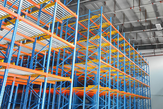 Pallet flow racks for high-density warehouse storage