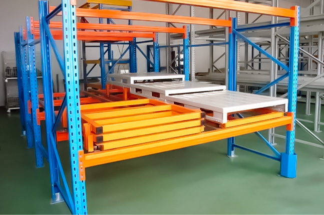 A push back pallet racking system with inclined rails designed for dense pallet storage in warehouses