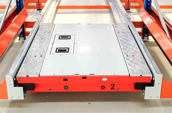 Radio shuttle vehicle operating inside a pallet shuttle racking system for high-density pallet storage