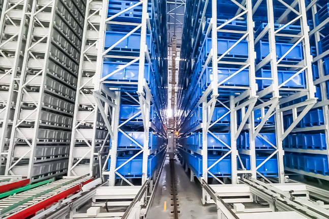 Mini Load AS/RS with tote storage racks and a stacker crane operating in the aisle