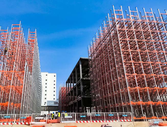 Rack-supported ASRS warehouse under construction, showing the main racking structure built as the outer framework of the warehouse.