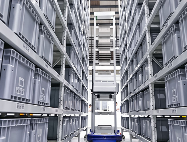 Automated tote handling robot operating in a high-density storage rack system.